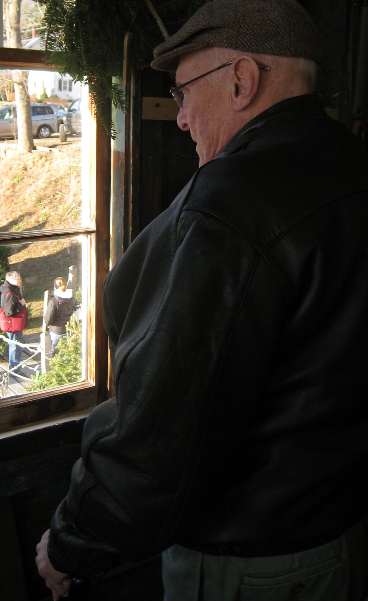 elderly man gazing out window